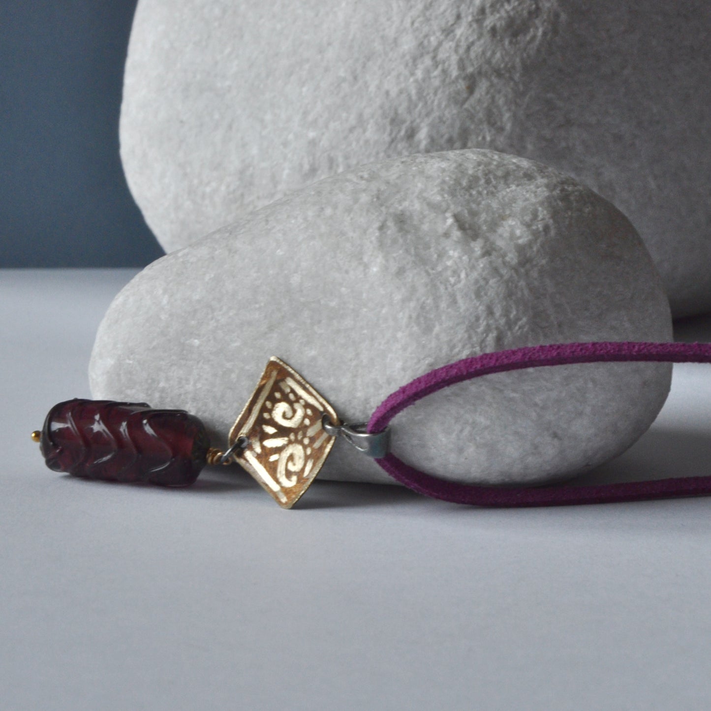 Necklace with patinated and hand-engraved brass pendant and glass cylinder 'Eggplant with Gold Glitter'
