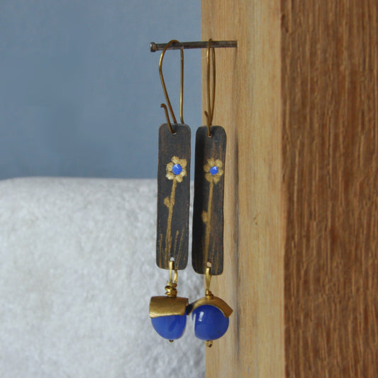Handmade long brass earrings in gold color with blue floral motif 'Flower in Blue'