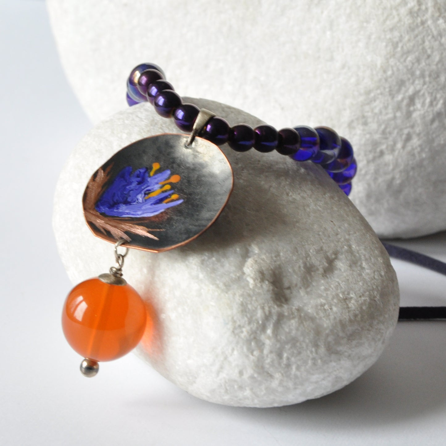 Necklace with patinated hand-forged & engraved copper pendant with enameled flower and orange resin smooth ball 'Dark Blue Lily'