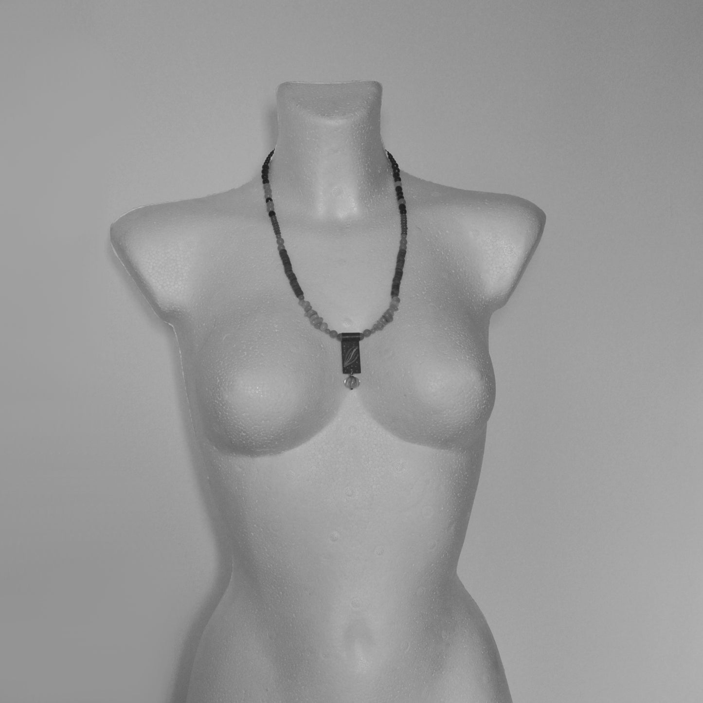 Necklace with a brass pendant, patinated and enameled & with gemstones 'Coral in a Celadon Setting'