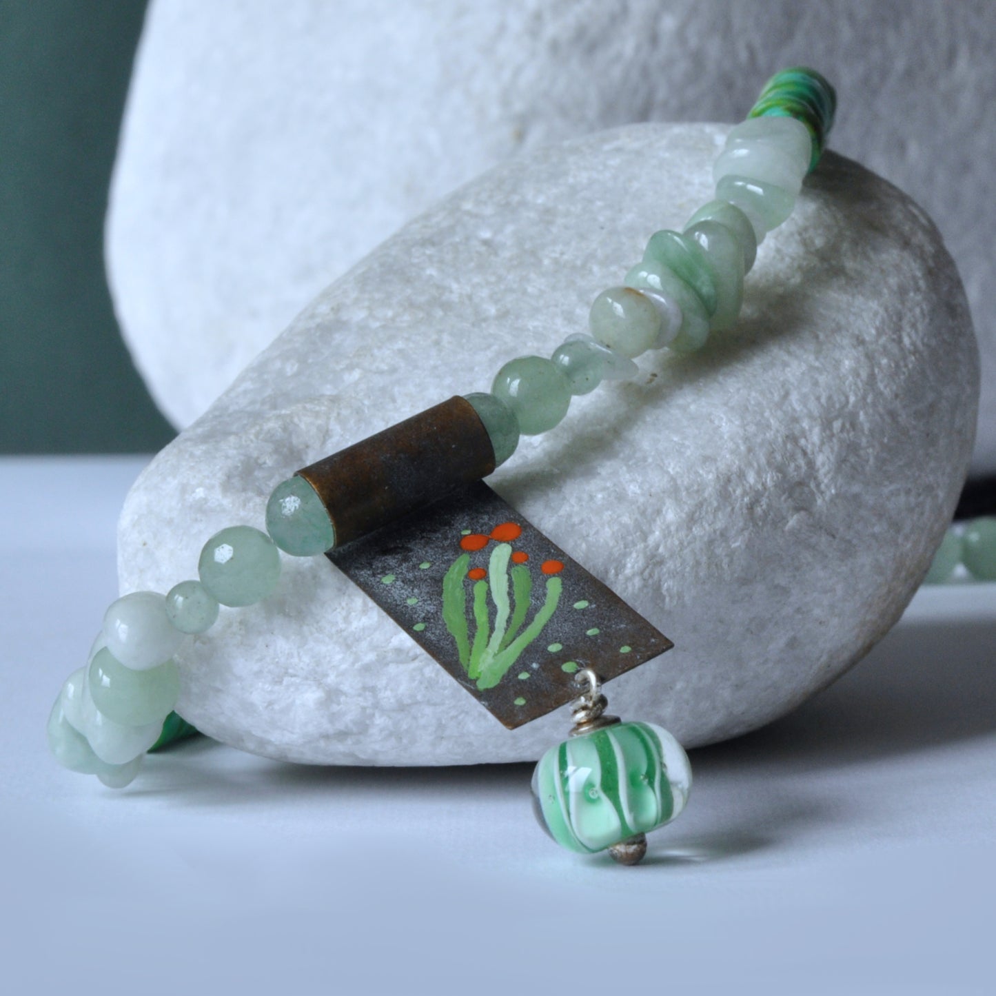 Necklace with a brass pendant, patinated and enameled & with gemstones 'Coral in a Celadon Setting'