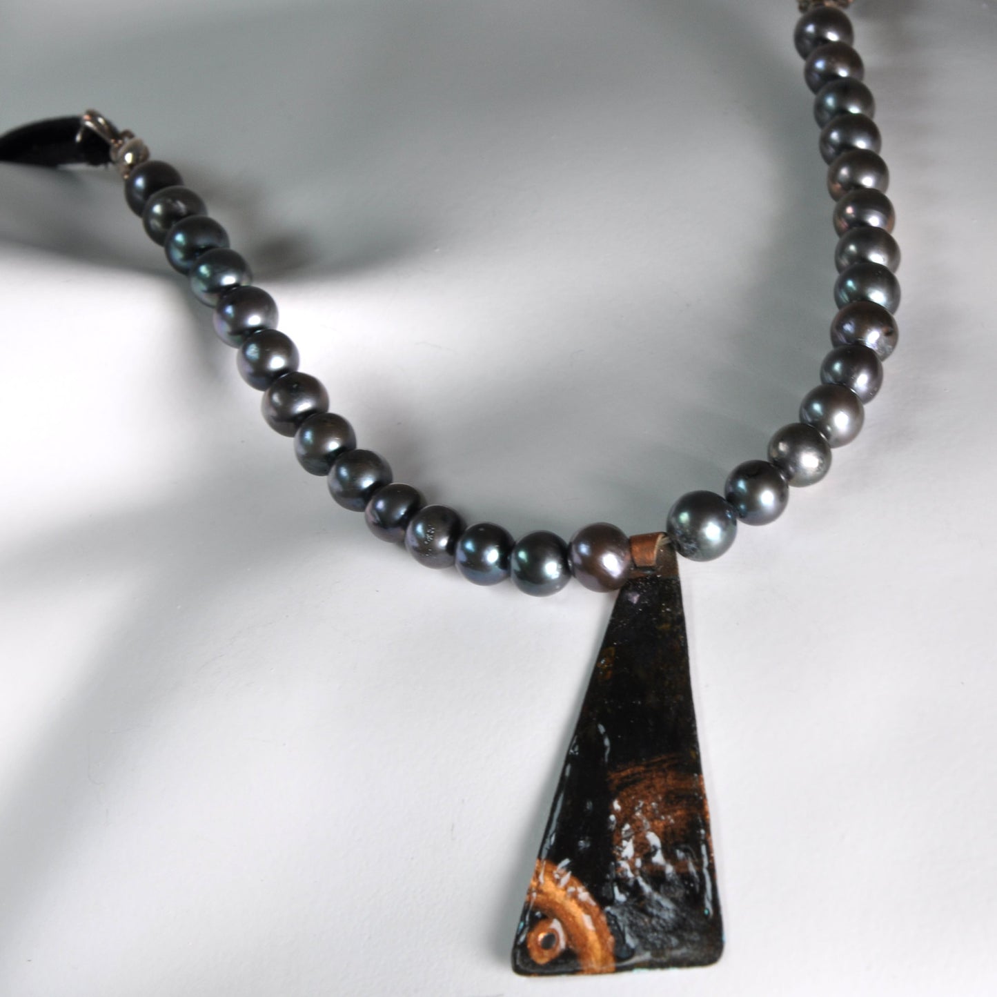 Necklace with a pendant of patinated copper and natural dark pearls 'Black Fish'