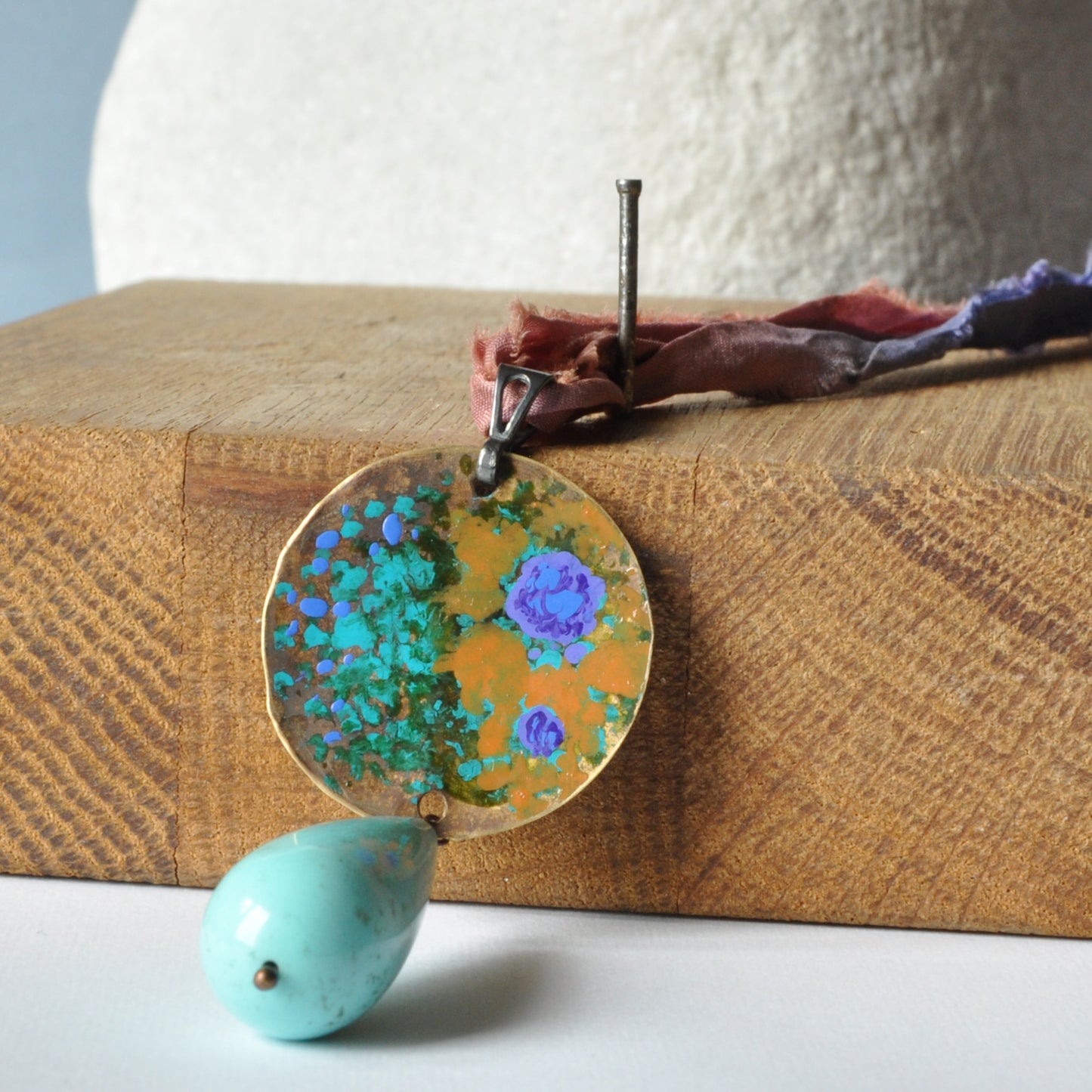 Raw silk necklace with a forged enameled brass pendant and a drop of howlite 'From the Studio Windows'