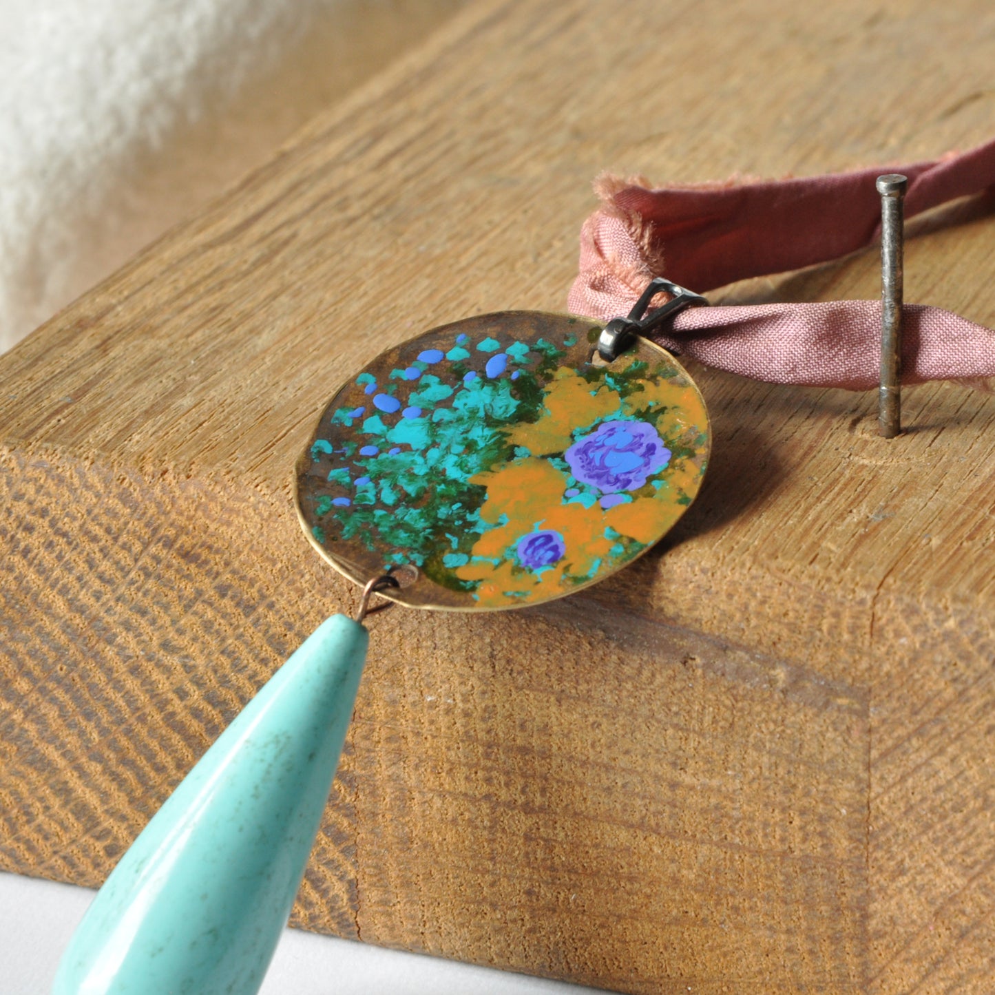 Raw silk necklace with a forged enameled brass pendant and a drop of howlite 'From the Studio Windows'
