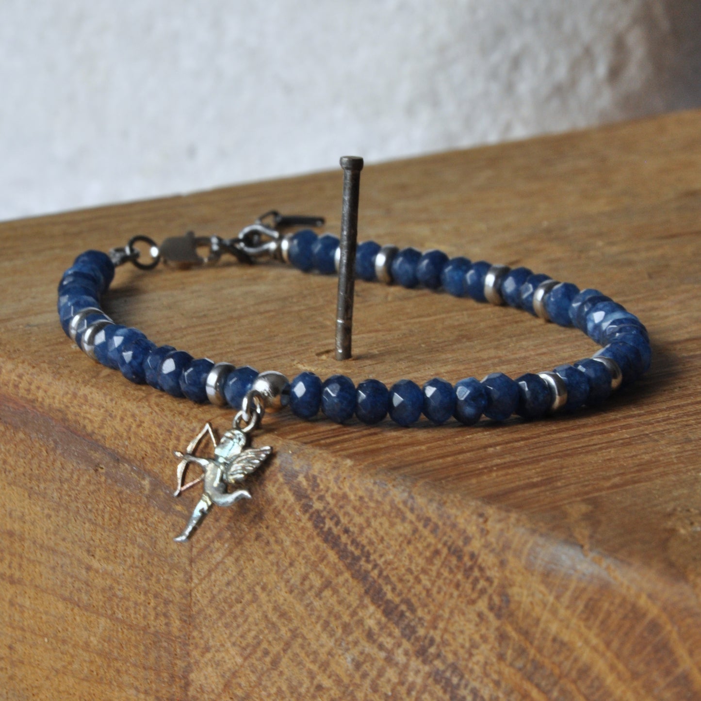 Silver bracelet with agates and hematites and a fine pendant in the form of a cupid 'Evening in Rome'