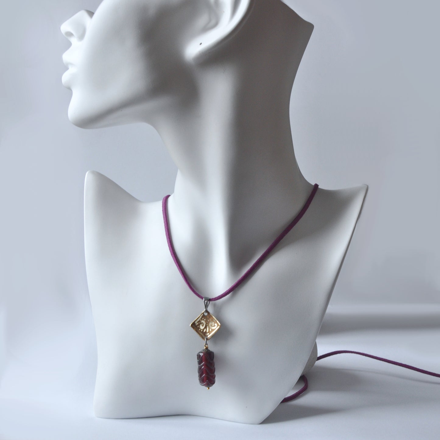 Necklace with patinated and hand-engraved brass pendant and glass cylinder 'Eggplant with Gold Glitter'
