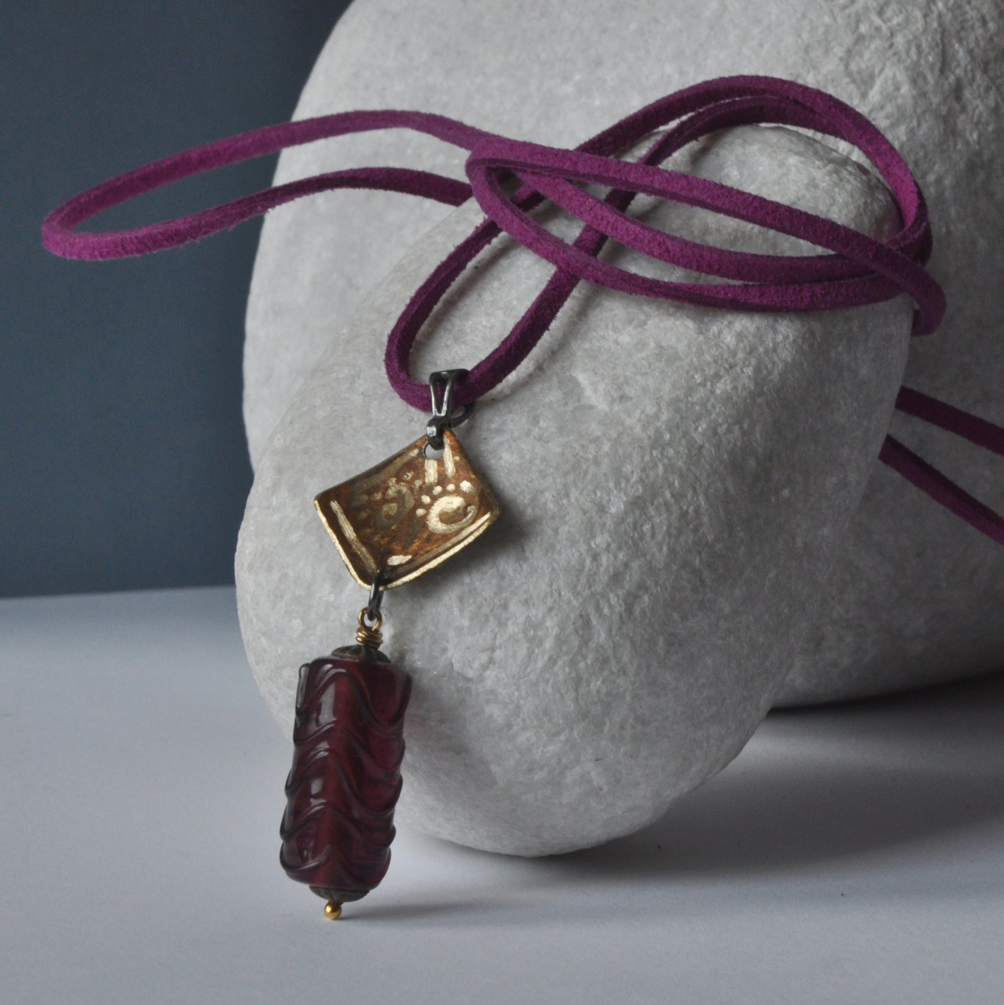 Necklace with patinated and hand-engraved brass pendant and glass cylinder 'Eggplant with Gold Glitter'