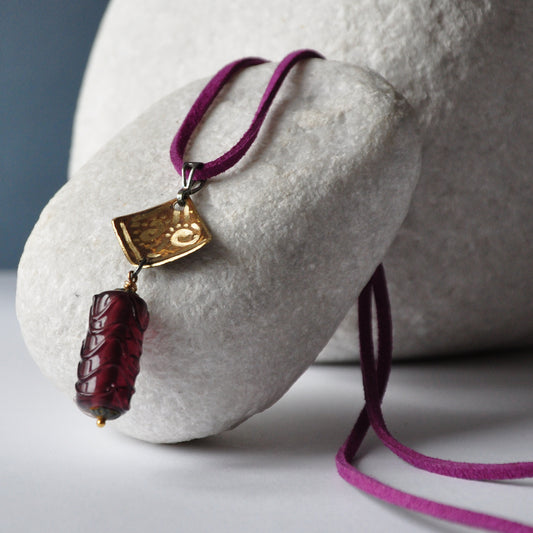 Necklace with patinated and hand-engraved brass pendant and glass cylinder 'Eggplant with Gold Glitter'
