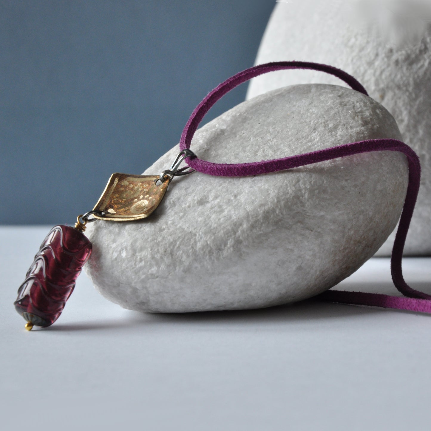 Necklace with patinated and hand-engraved brass pendant and glass cylinder 'Eggplant with Gold Glitter'