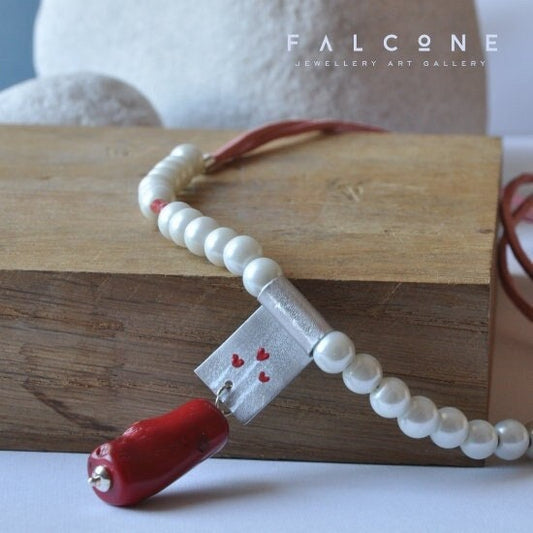 Long necklace of glass pearls with enameled aluminium pendant and worm coral 'Three Hearts'