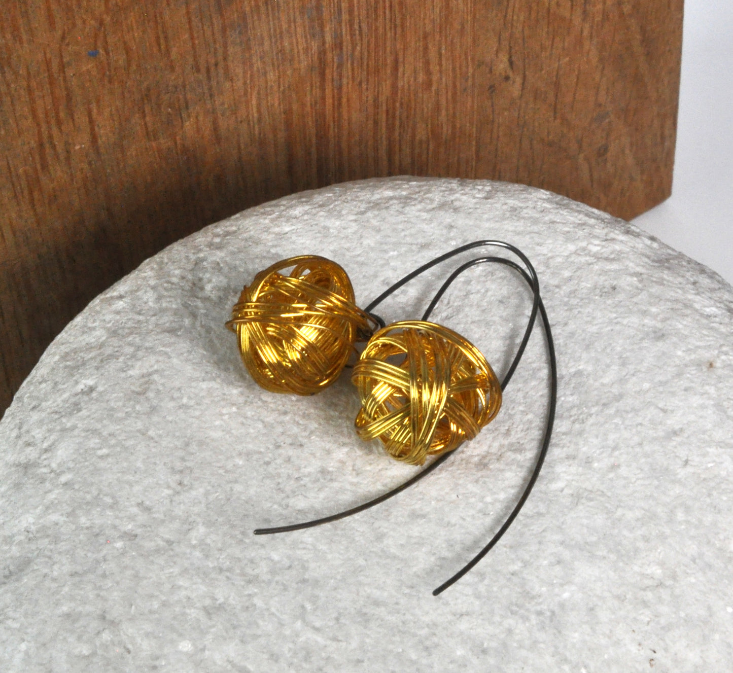 Geometric dangling earrings of brass and silver 'Golden Motes'