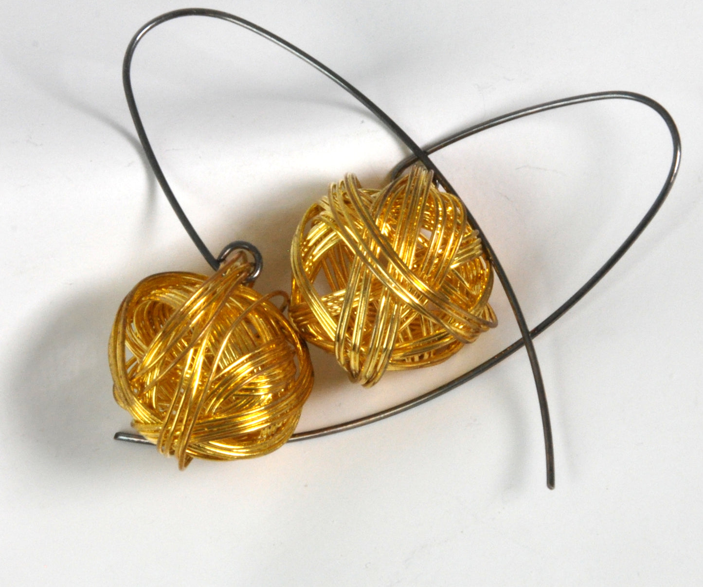 Geometric dangling earrings of brass and silver 'Golden Motes'