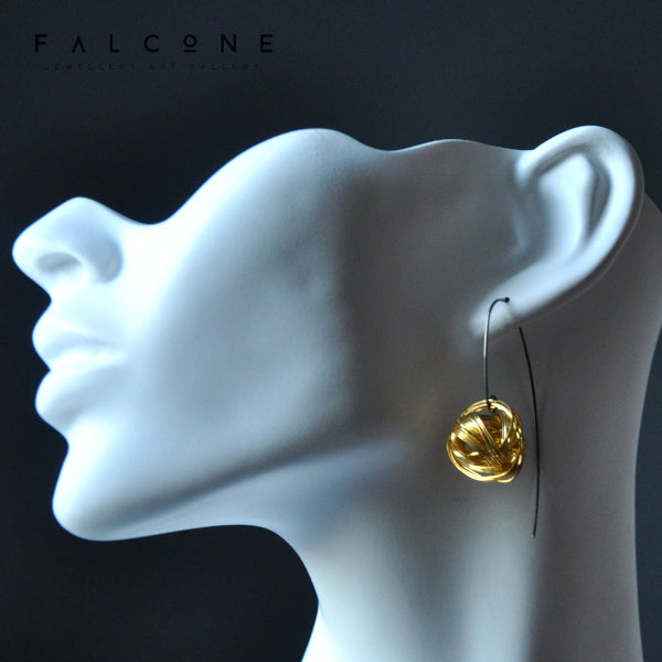 Geometric dangling earrings of brass and silver 'Golden Motes'