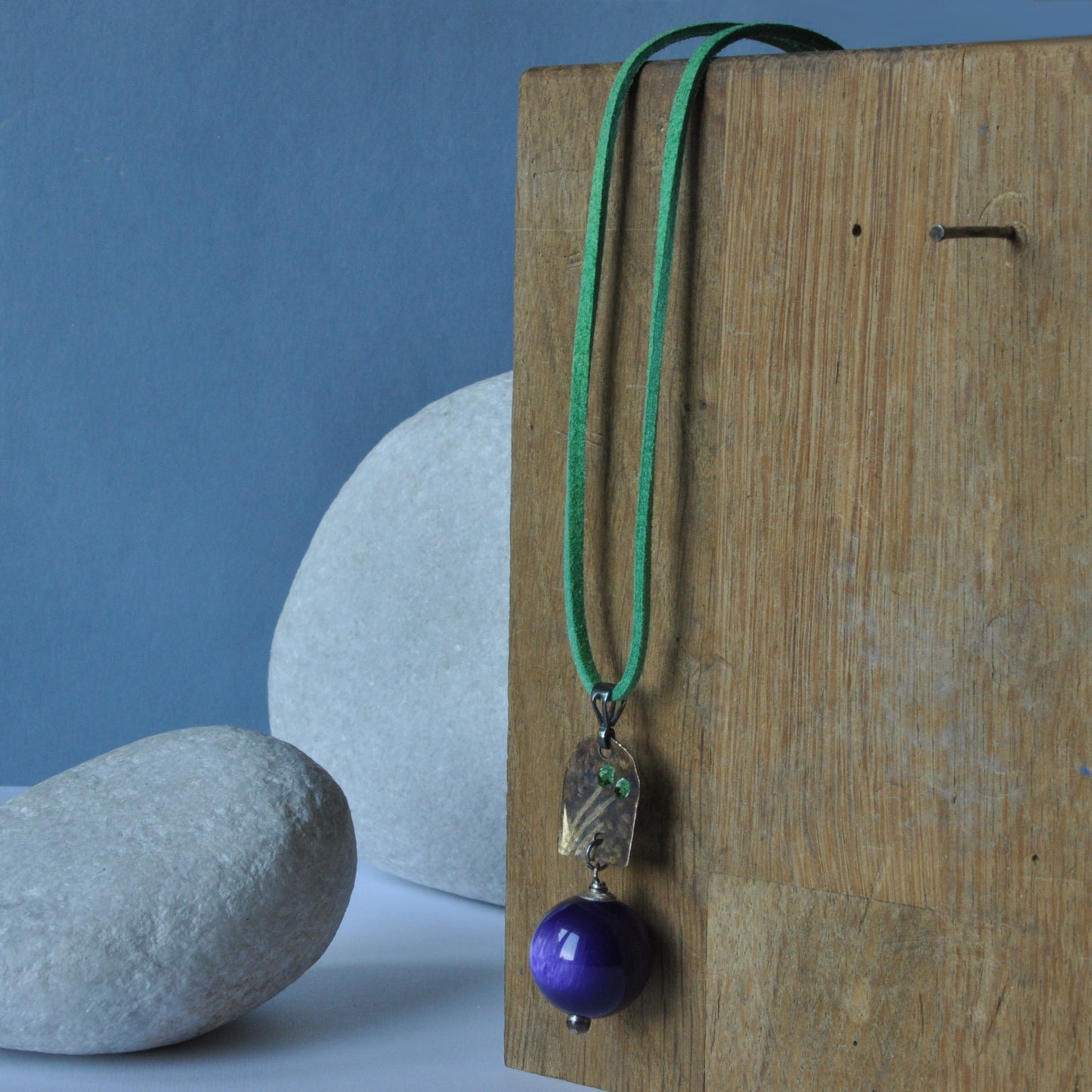 Necklace with patinated brass and engraved pendant and resin ball 'In Green Flowers and Purple'