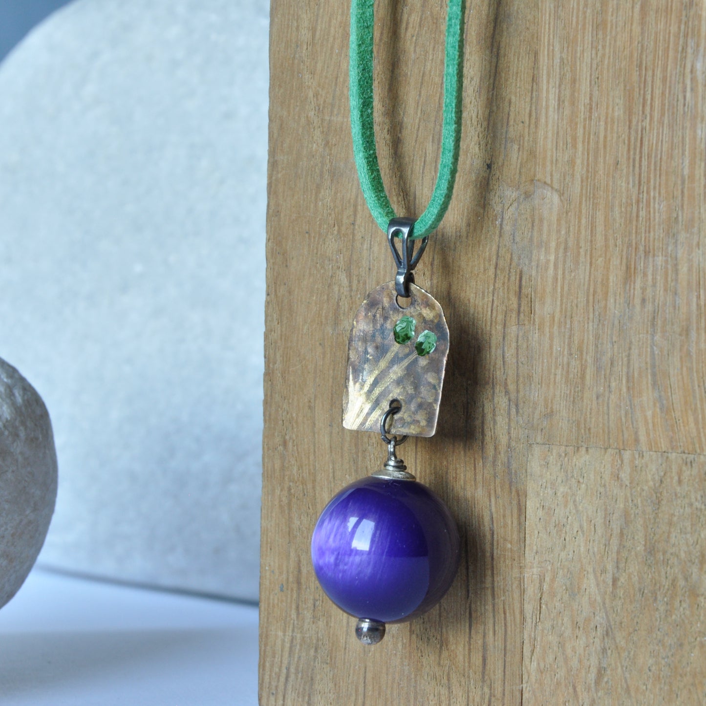 Necklace with patinated brass and engraved pendant and resin ball 'In Green Flowers and Purple'