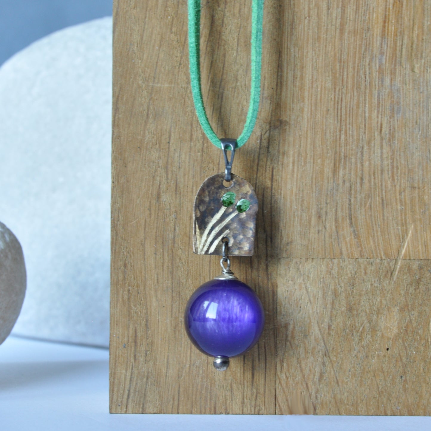 Necklace with patinated brass and engraved pendant and resin ball 'In Green Flowers and Purple'