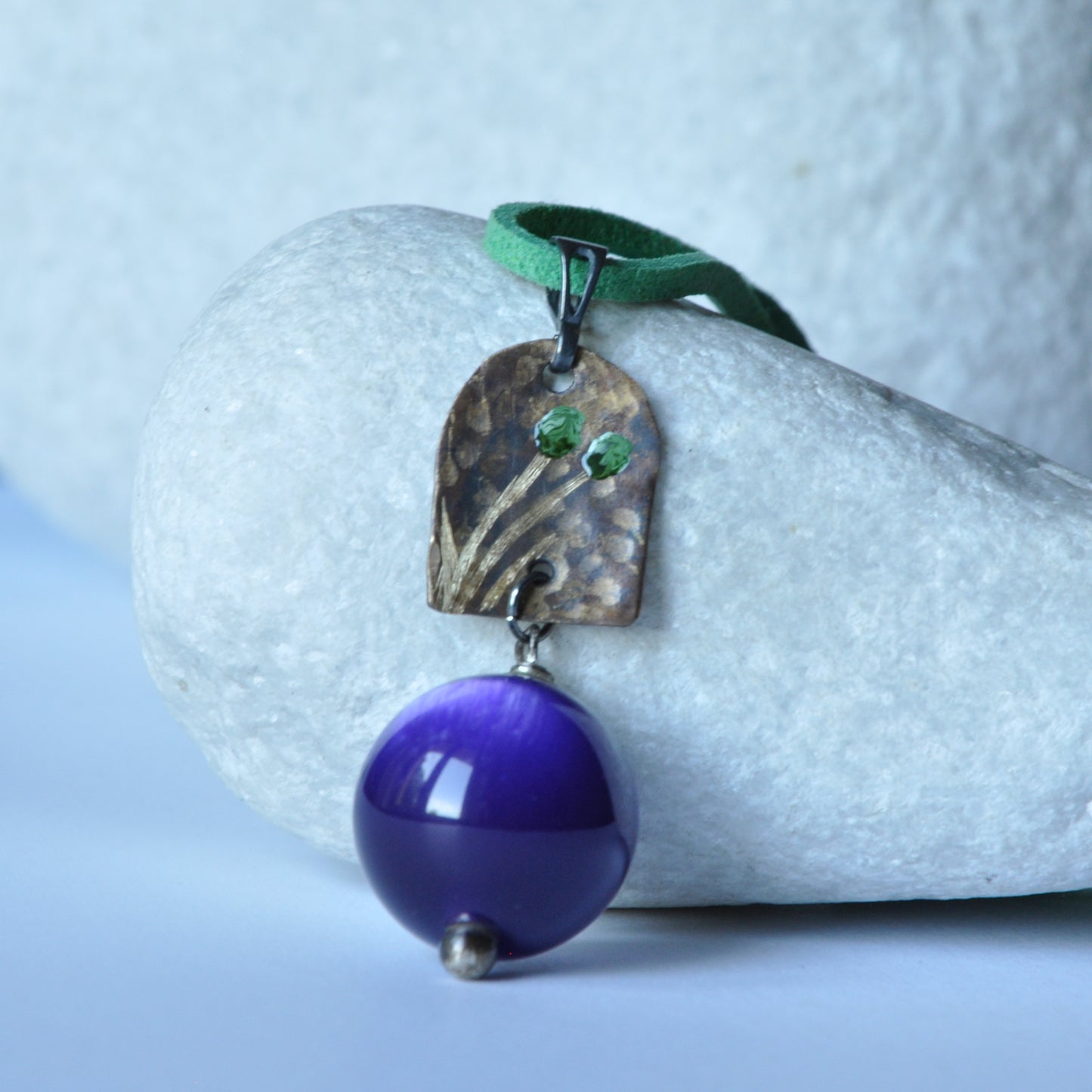 Necklace with patinated brass and engraved pendant and resin ball 'In Green Flowers and Purple'