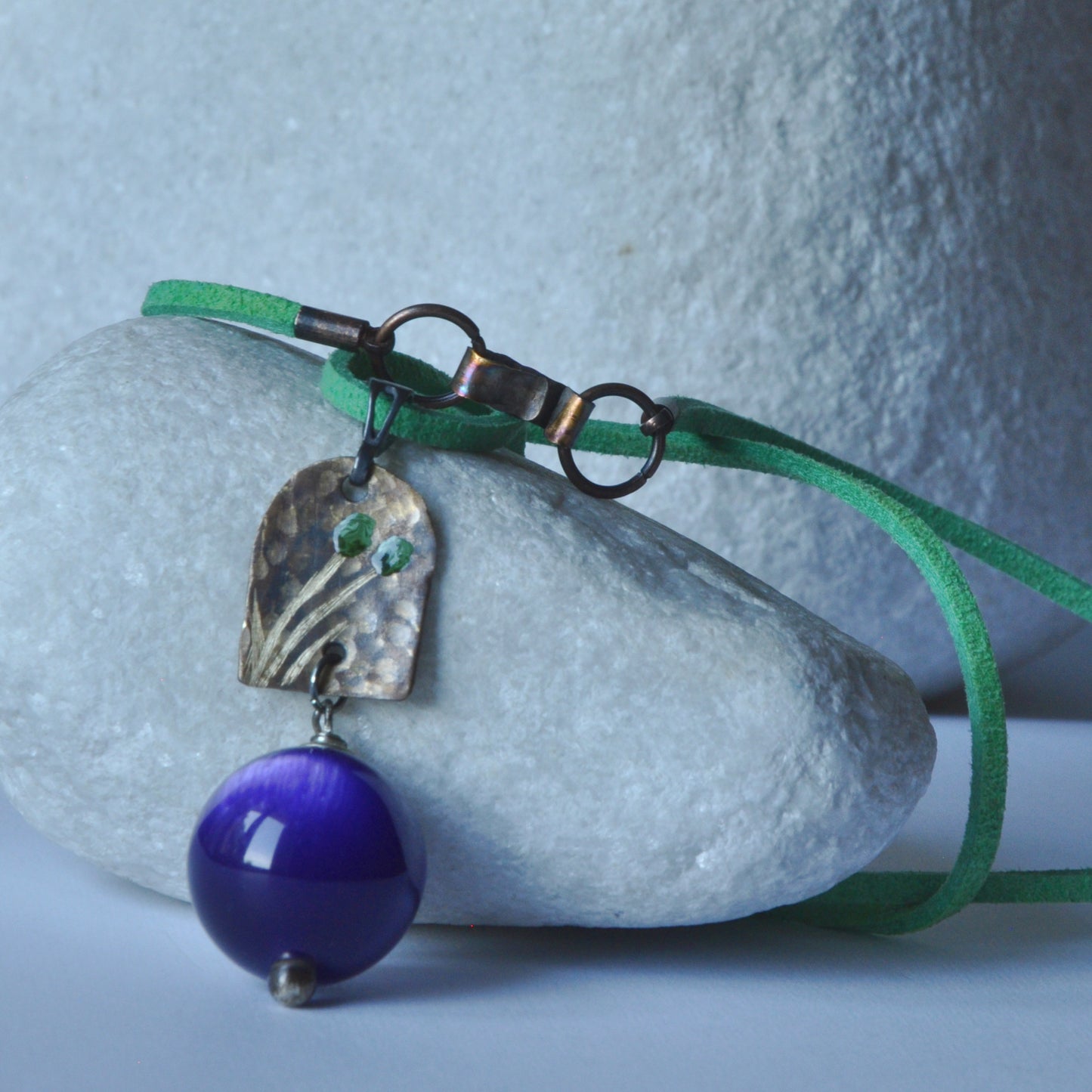 Necklace with patinated brass and engraved pendant and resin ball 'In Green Flowers and Purple'